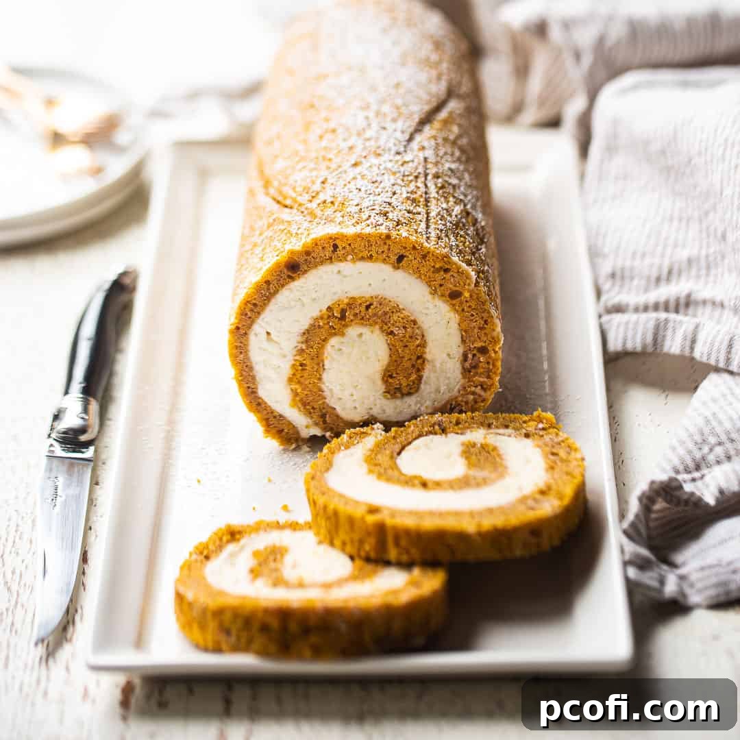Pumpkin roll served on a rectangular white ceramic plate.