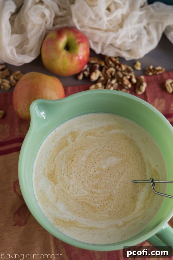 The bread cubes soaking in the rich custard, a foundational element of the Apple Walnut Bread Pudding.