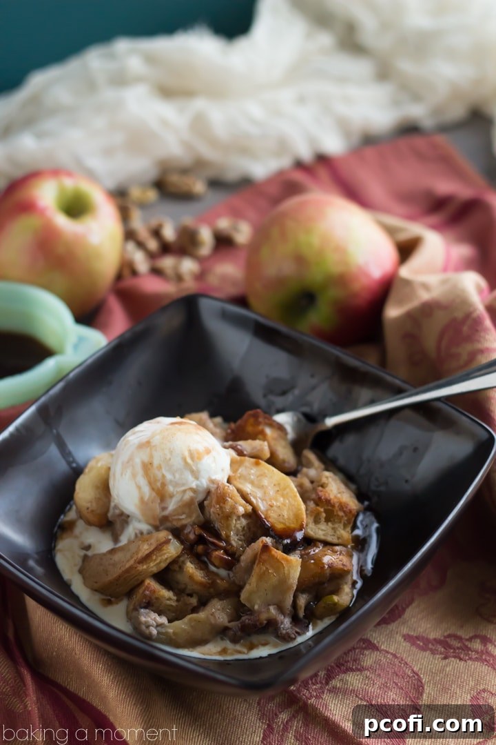 A close-up shot of the finished Apple Walnut Bread Pudding with Cinnamon Cider Sauce, ready to be served.