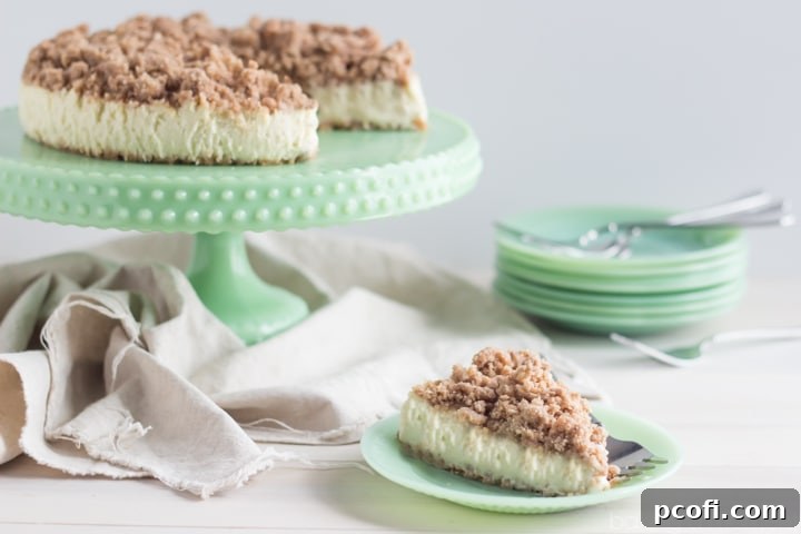 A close-up shot of a New York Crumb Cheesecake slice on a plate, ready to be served and enjoyed.