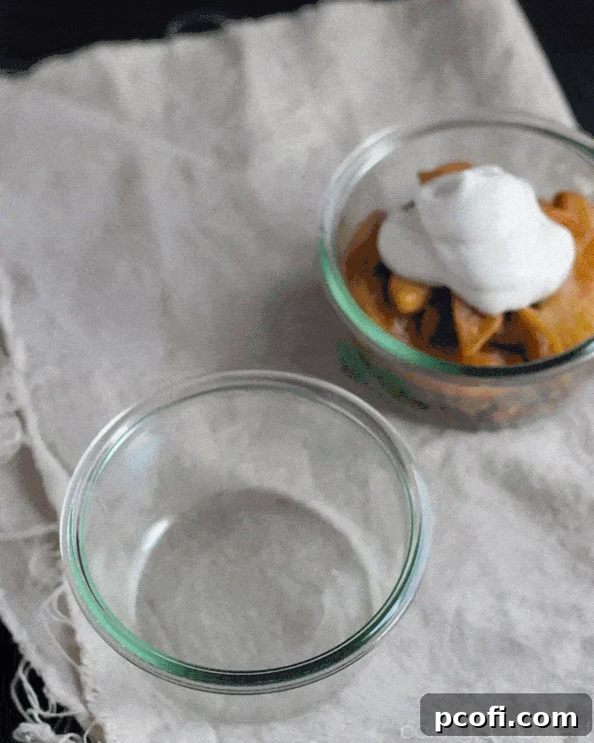 Luscious layers of homemade granola, warm spiced apples, and light whipped coconut cream, creating a guilt-free fall dessert.