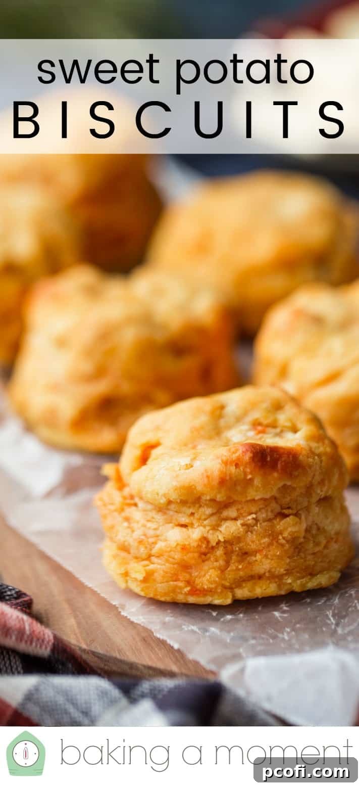 Close-up image of homemade sweet potato biscuits on a wooden board, with a text overlay reading "Sweet Potato Biscuits."