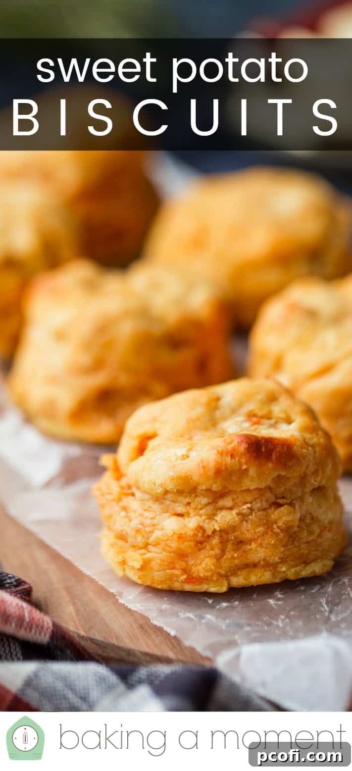 Close-up image of homemade sweet potato biscuits on a wooden board, with a text overlay reading "Sweet Potato Biscuits."