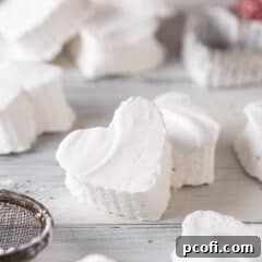 Homemade marshmallows cut into heart shapes, showcasing their fluffy texture.