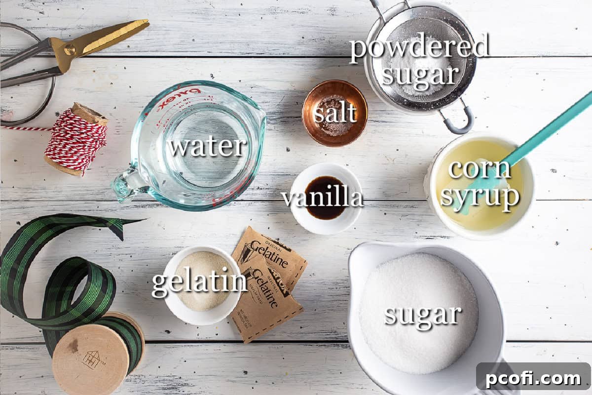 A selection of essential ingredients laid out for making homemade marshmallows, including gelatin, sugar, and vanilla extract.