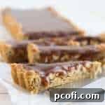 Snickers Blondie Tart in a rectangular pan, showcasing the delicious layers before serving.