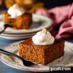 A top-down view of a classic gingerbread cake, warm and inviting, with a rich, dark brown crust suggesting its spicy sweetness, perfect for the holiday season.