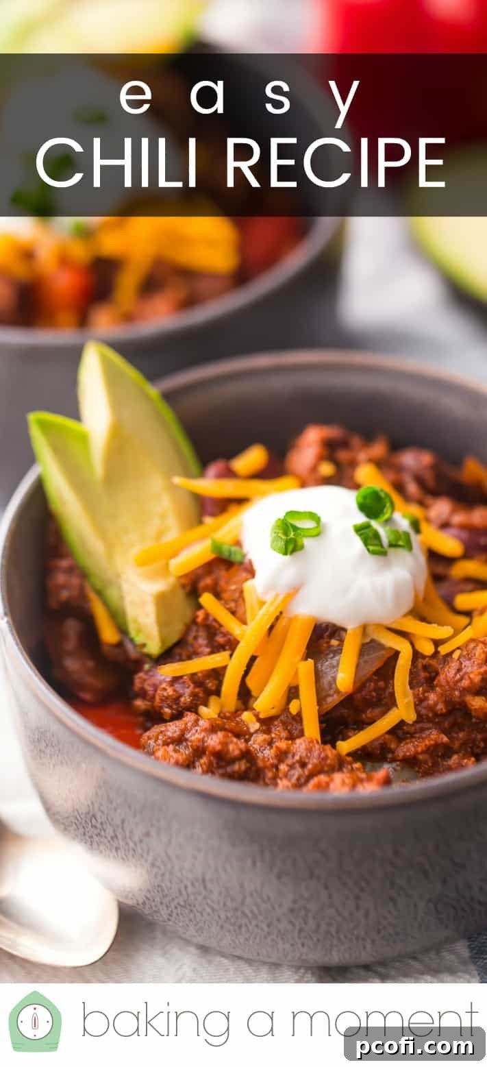 Close-up image of a bowl of chili, topped with cheese, sour cream, and avocado, with a text overlay reading "Easy Chili Recipe."
