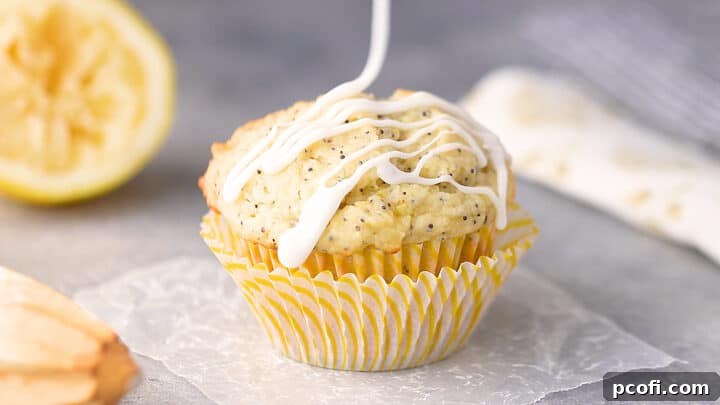 Drizzling a freshly baked lemon poppy seed muffin with tangy lemon glaze.