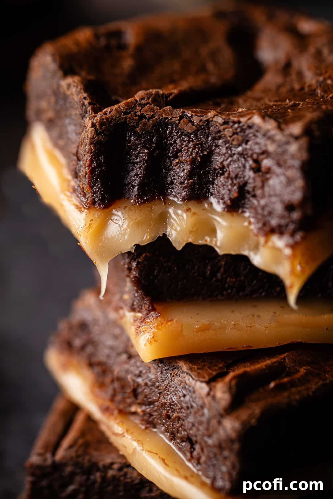 A close-up of a salted caramel brownie, showcasing the distinct layers of gooey caramel beneath the rich chocolate brownie.