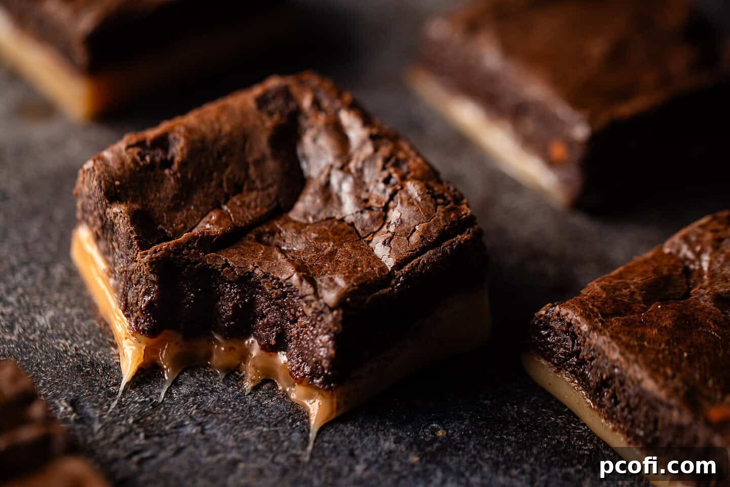Salted caramel brownie recipe baked and cut into squares, showing off the perfectly layered dessert.