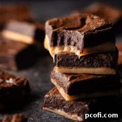 Salted caramel brownies stacked on top of one another.