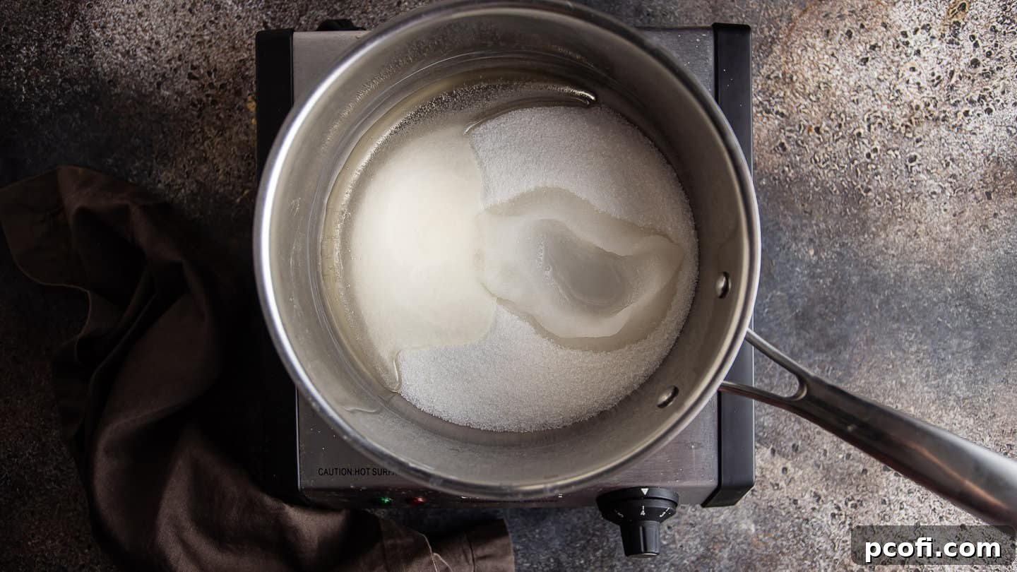 Cooking sugar, corn syrup, and water together in a medium pot over medium-high heat.