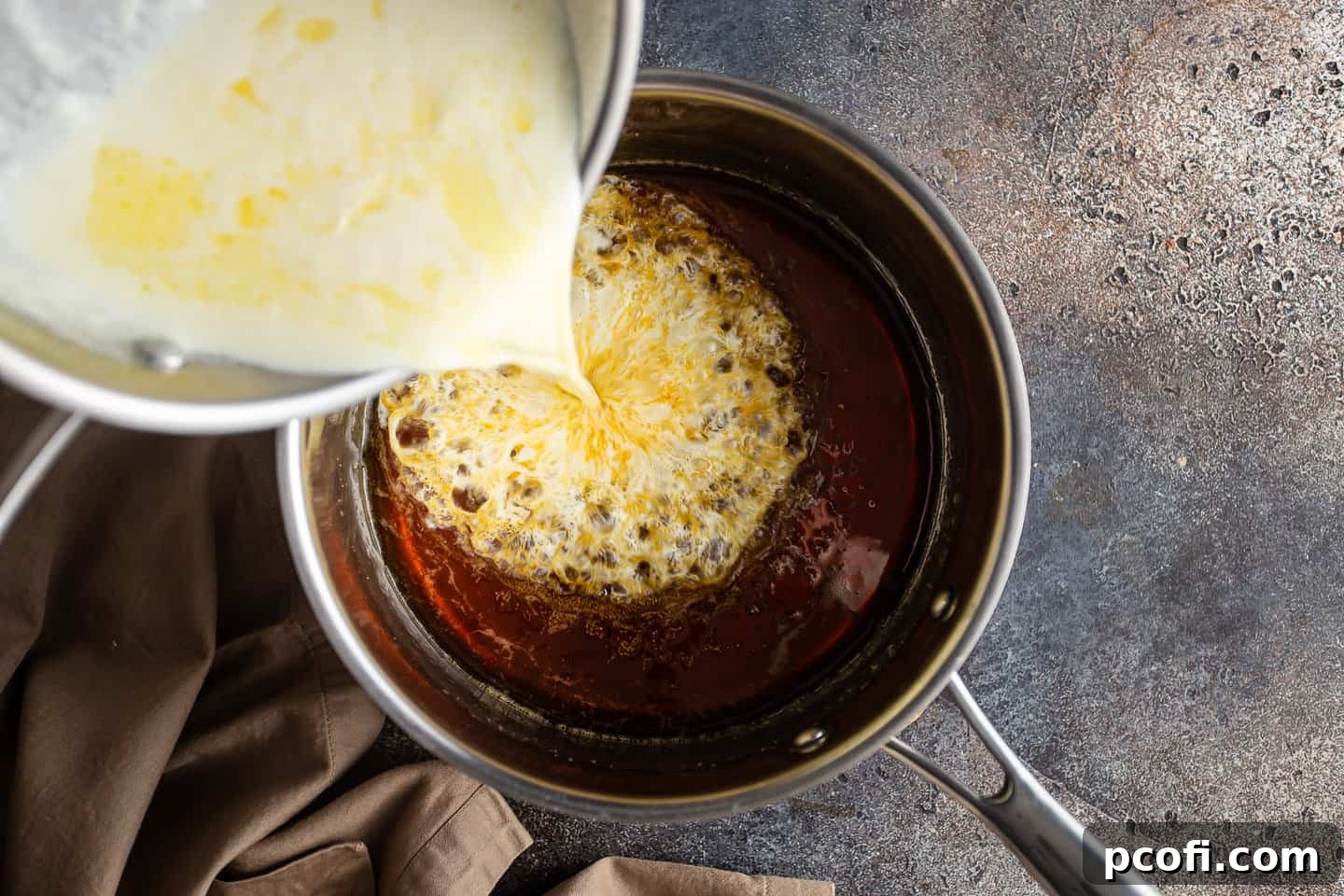 Pouring hot cream into caramelized sugar, which creates a vigorous bubbling reaction.