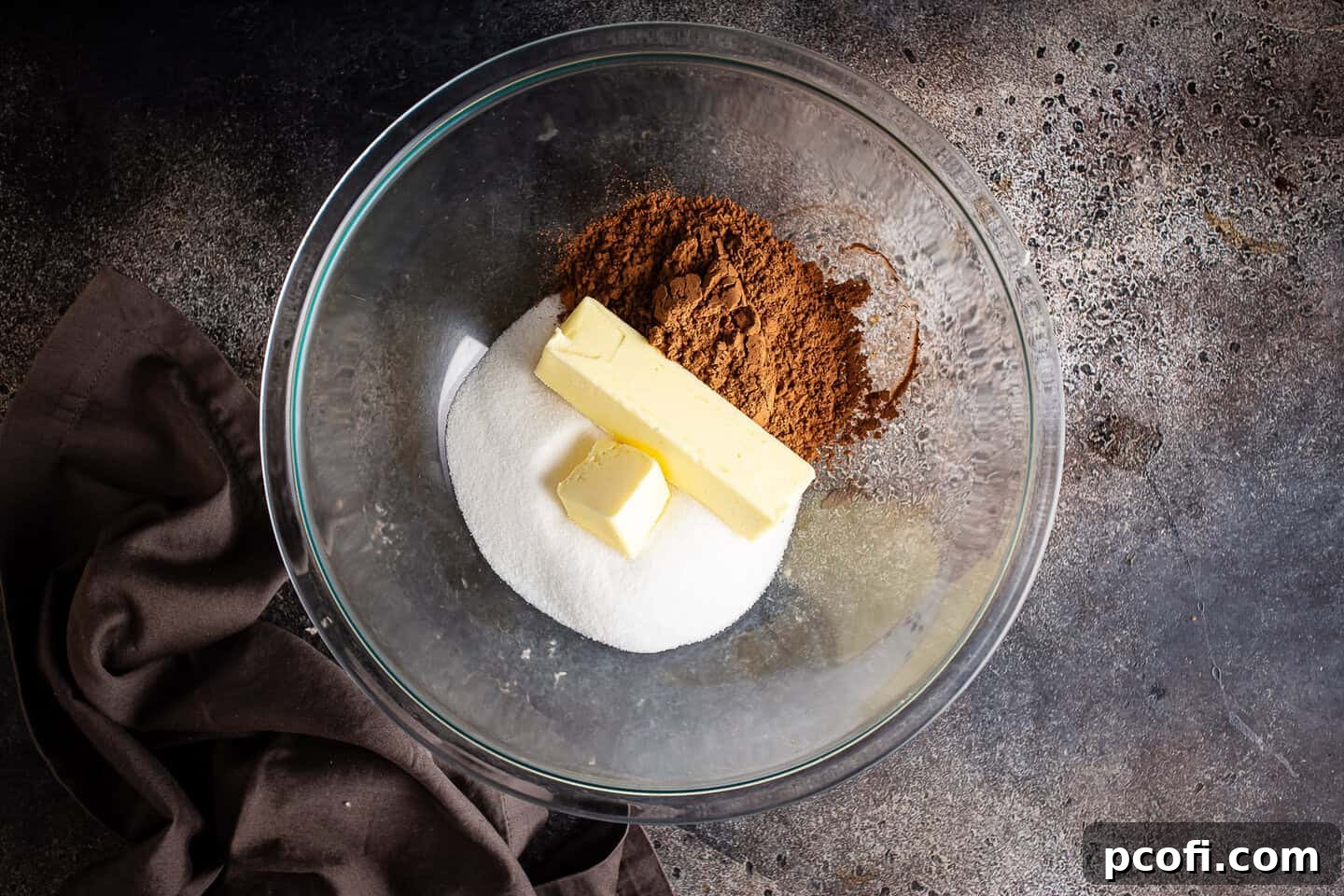 Sugar, cocoa, and butter measured and placed in a large mixing bowl.