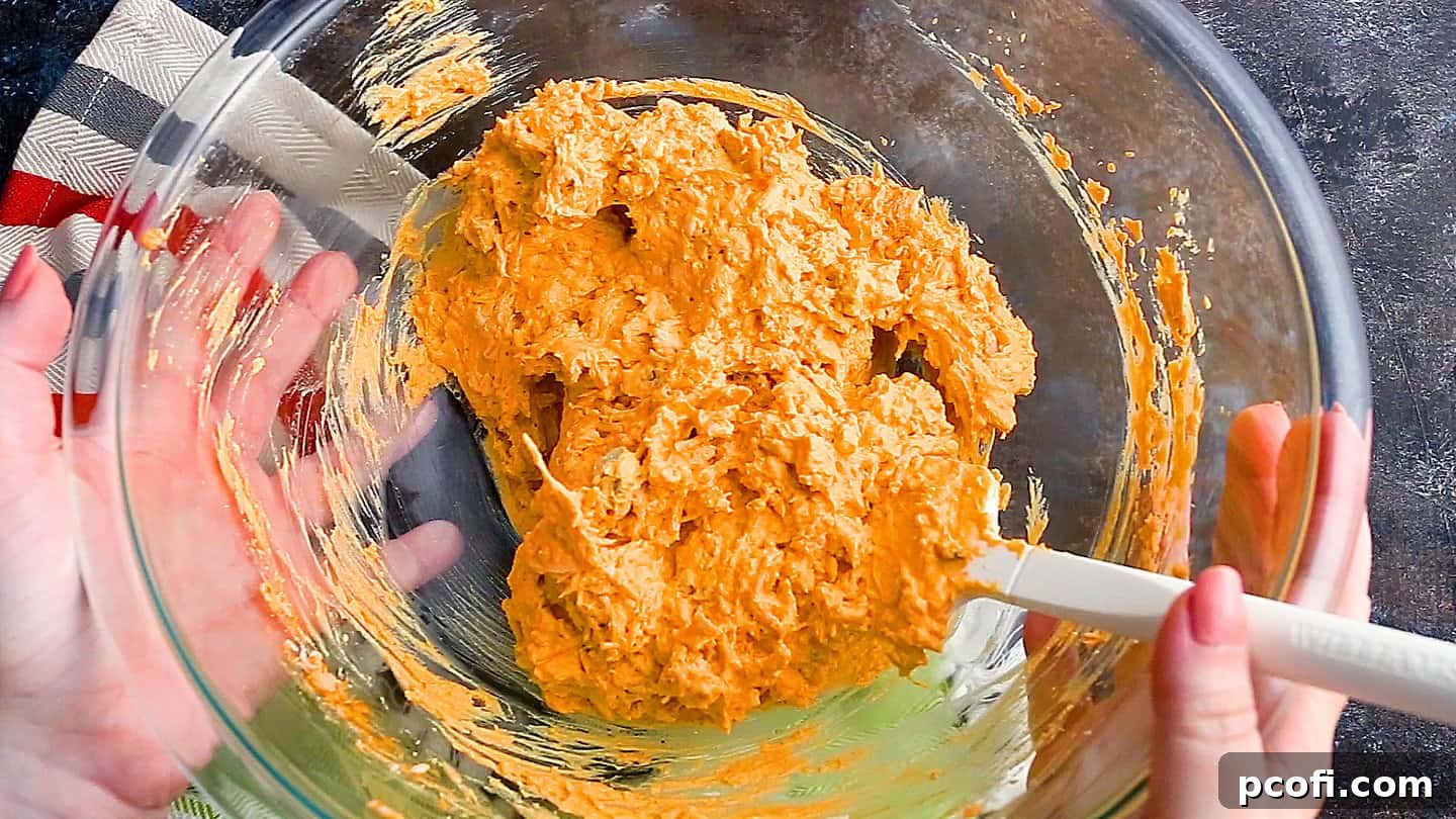 Buffalo chicken dip fully mixed and ready for baking or slow cooking.