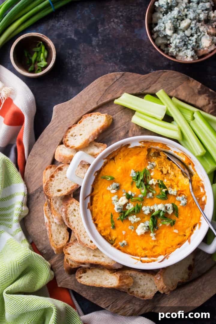 Crockpot Buffalo Chicken Dip Recipe, showing the texture of the shredded chicken in the dip.