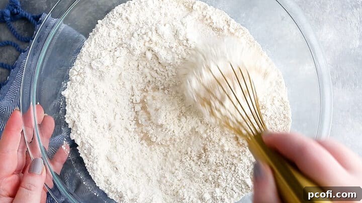 Whisking the dry ingredients together for croissants.