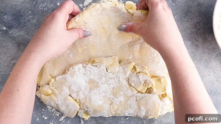 Folding croissant dough into thirds.