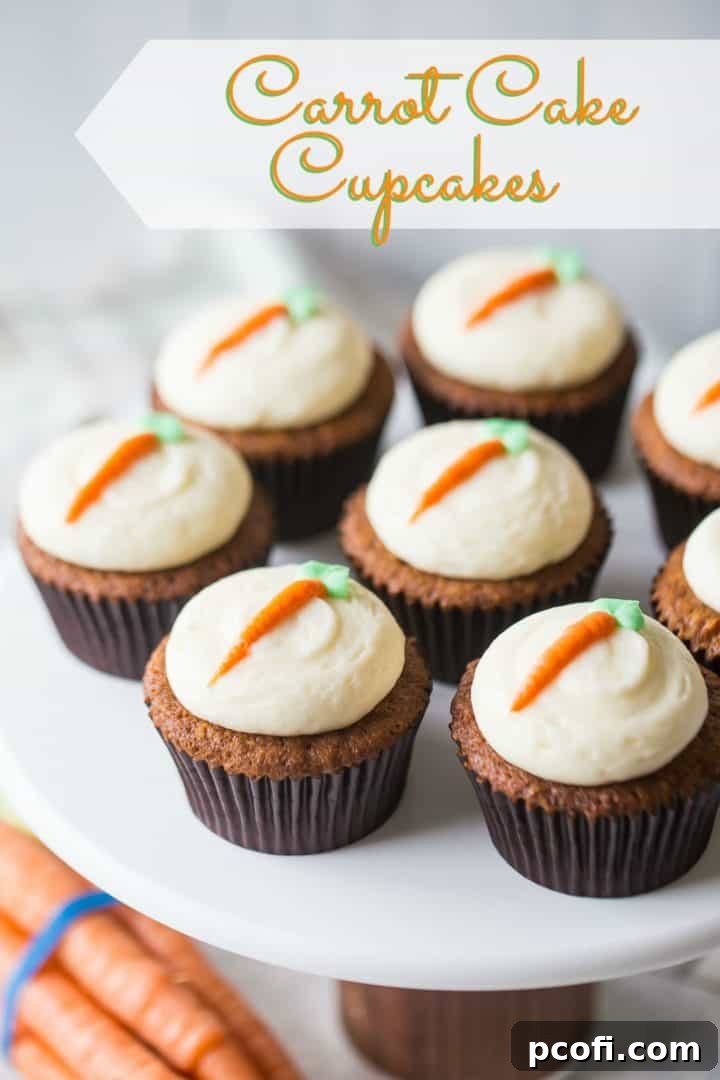 A display of freshly baked carrot cake cupcakes, each meticulously topped with swirls of luscious cream cheese frosting, arranged elegantly on a white cake stand against a soft, blurred background.