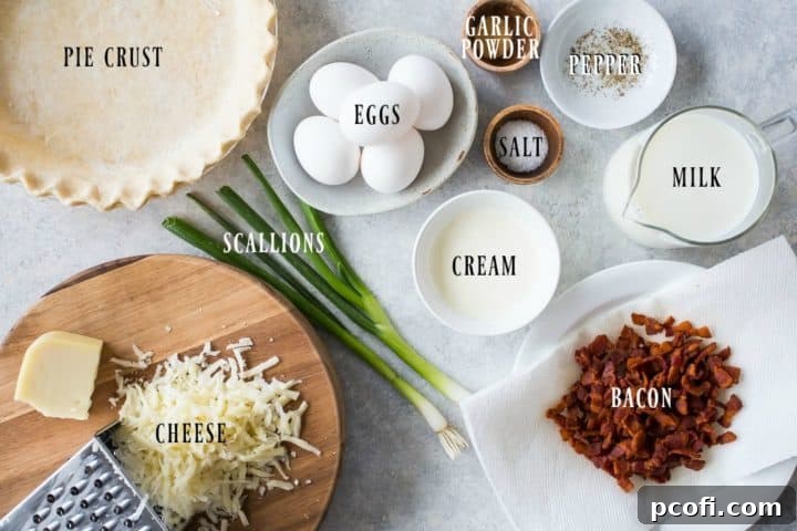 Overhead shot of all the fresh ingredients laid out for making quiche Lorraine, including eggs, milk, cream, bacon, Gruyere, and scallions.