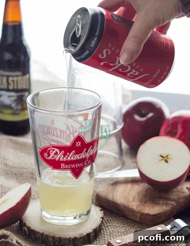 Close-up of a refreshing Velvet Apple Cocktail, highlighting the rich stout and golden cider layers