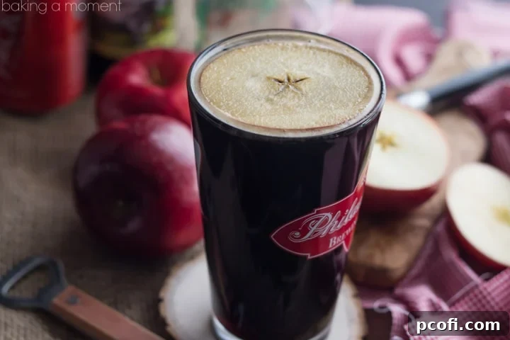A Velvet Apple Cocktail in a glass with an apple slice garnish, ready to be enjoyed