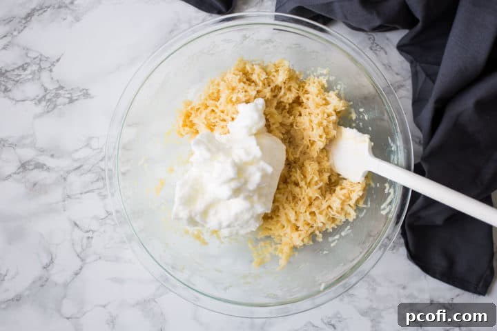 Bowl of coconut, condensed milk, and stiffly whipped egg whites for macaroons.