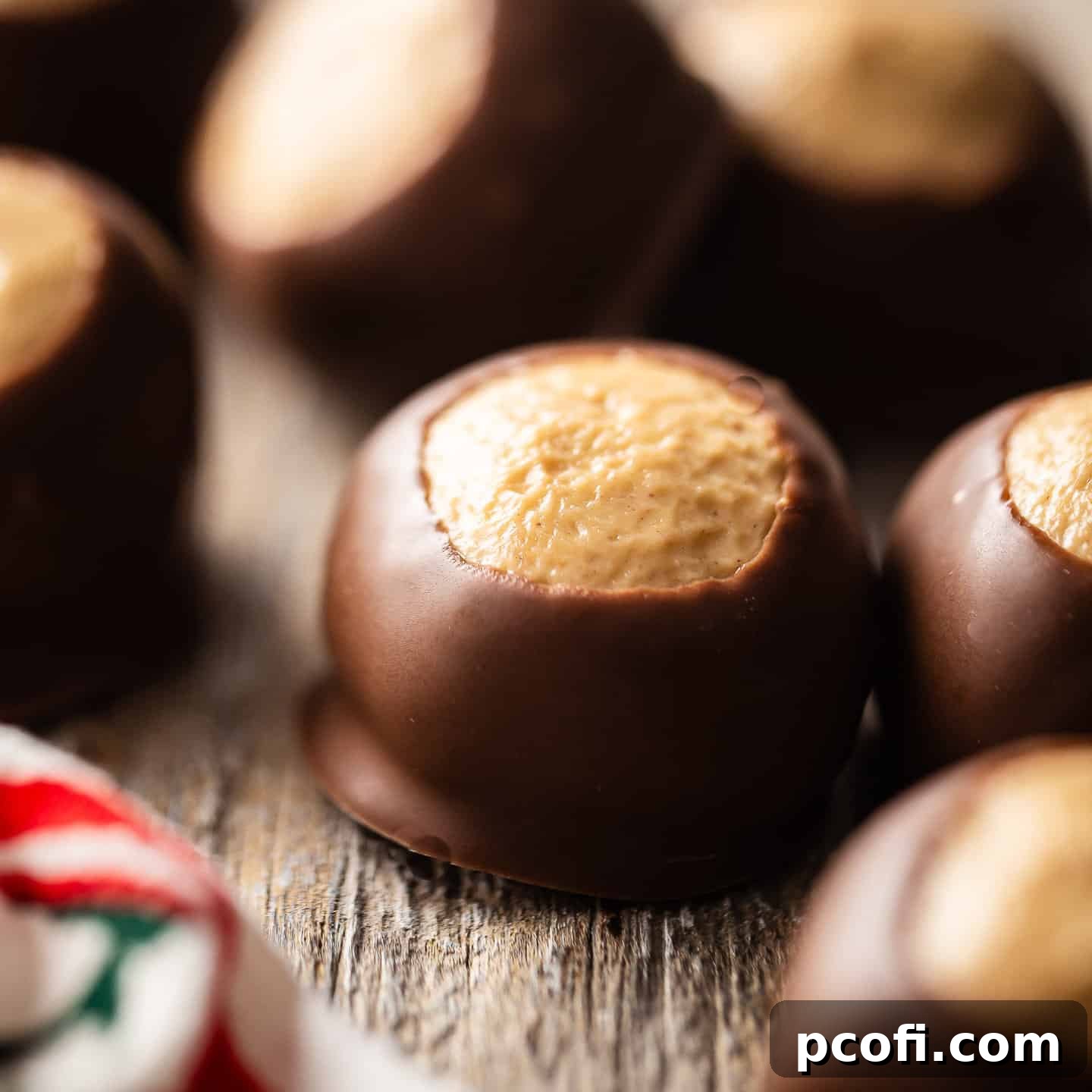 Buckeye candies, a classic chocolate and peanut butter treat, beautifully arranged on a rustic wood surface.