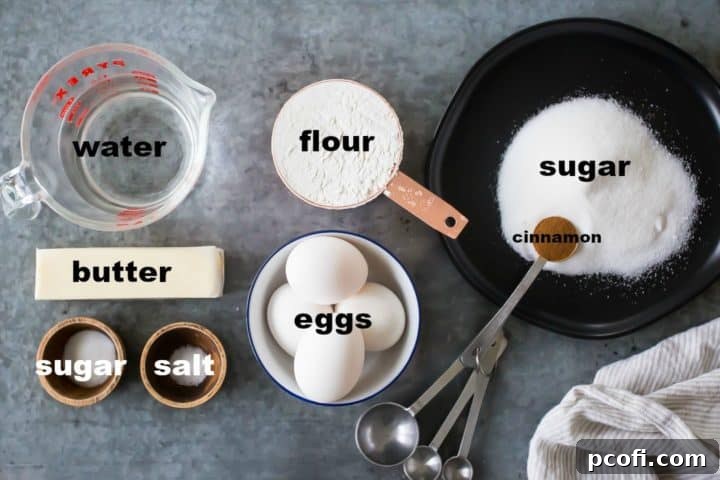 A curated collection of fresh ingredients for making churros, including water, butter, sugar, salt, flour, and eggs, neatly laid out on a clean surface, ready for preparation.