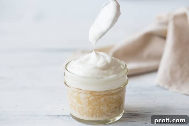 Topping tres leches cake with whipped cream.