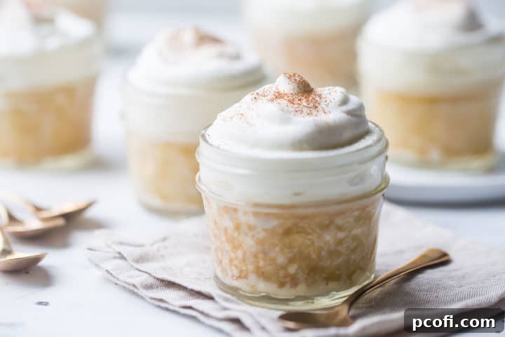Several individual tres leches cakes baked in glass jars.