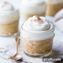 Tres leches cake baked in a small jar, topped with whipped cream.