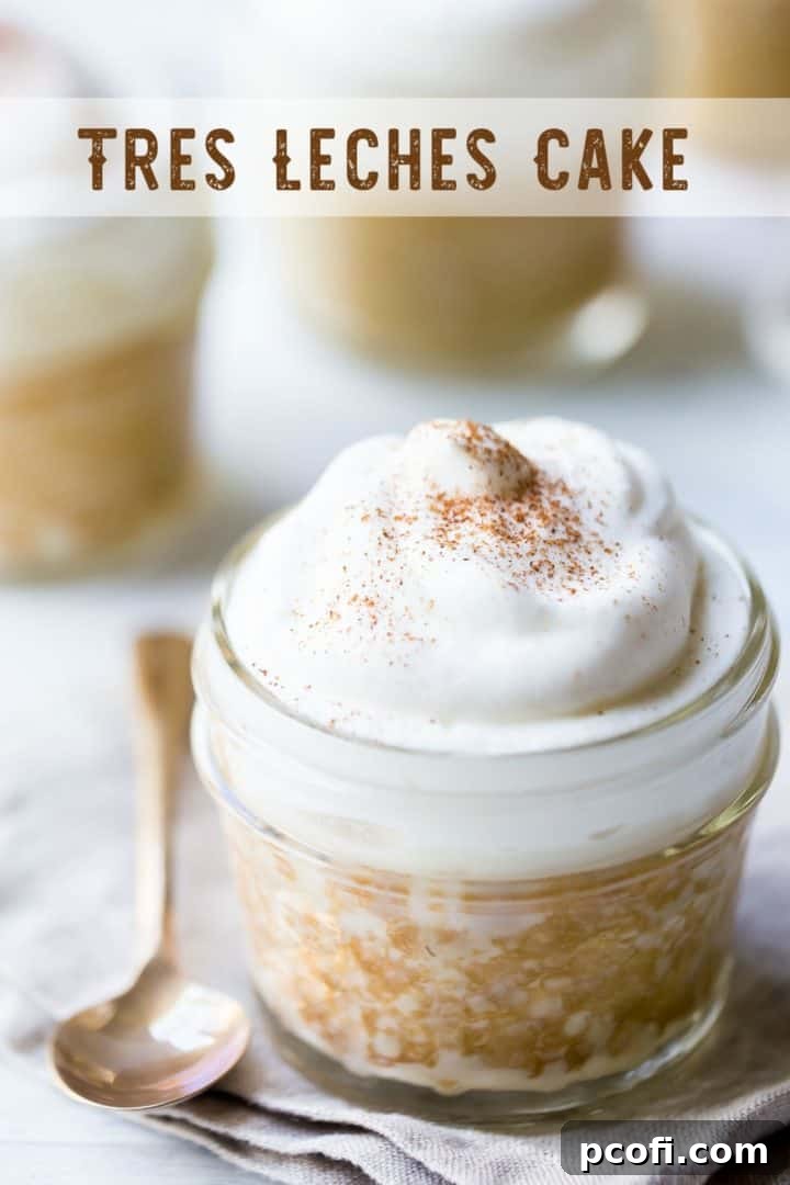 Tres leches cake with whipped cream in a small jar with a text overlay above reading "Tres Leches Cake."