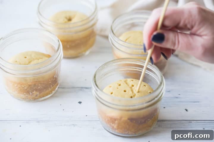 Piercing tres leches cake with a skewer.