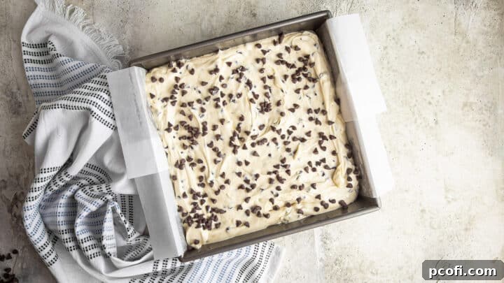 Sprinkling unbaked chocolate chip cake with additional chips for garnish.