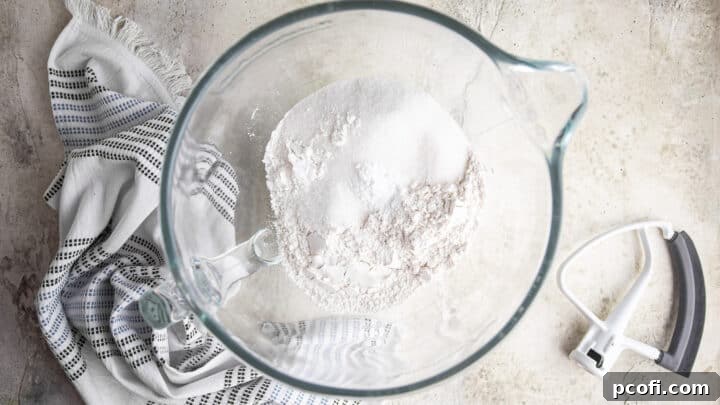 Dry ingredients for chocolate chip cake in a large glass mixing bowl.
