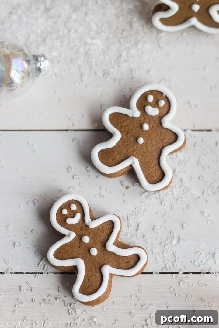 Smooth and easy-to-roll gingerbread cookie dough between parchment paper, ready for cutting.