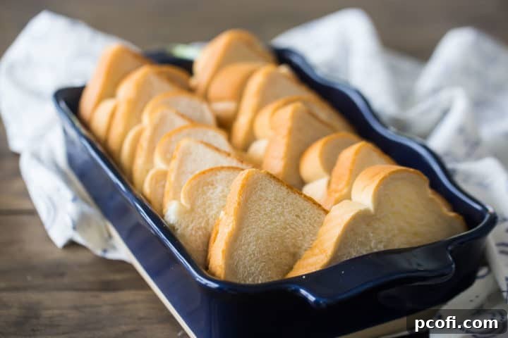 Arranging bread in a baking dish for French toast casserole.