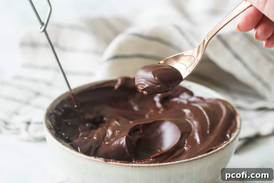 A spoonful of perfectly cooled ganache, demonstrating its thick, spreadable consistency.