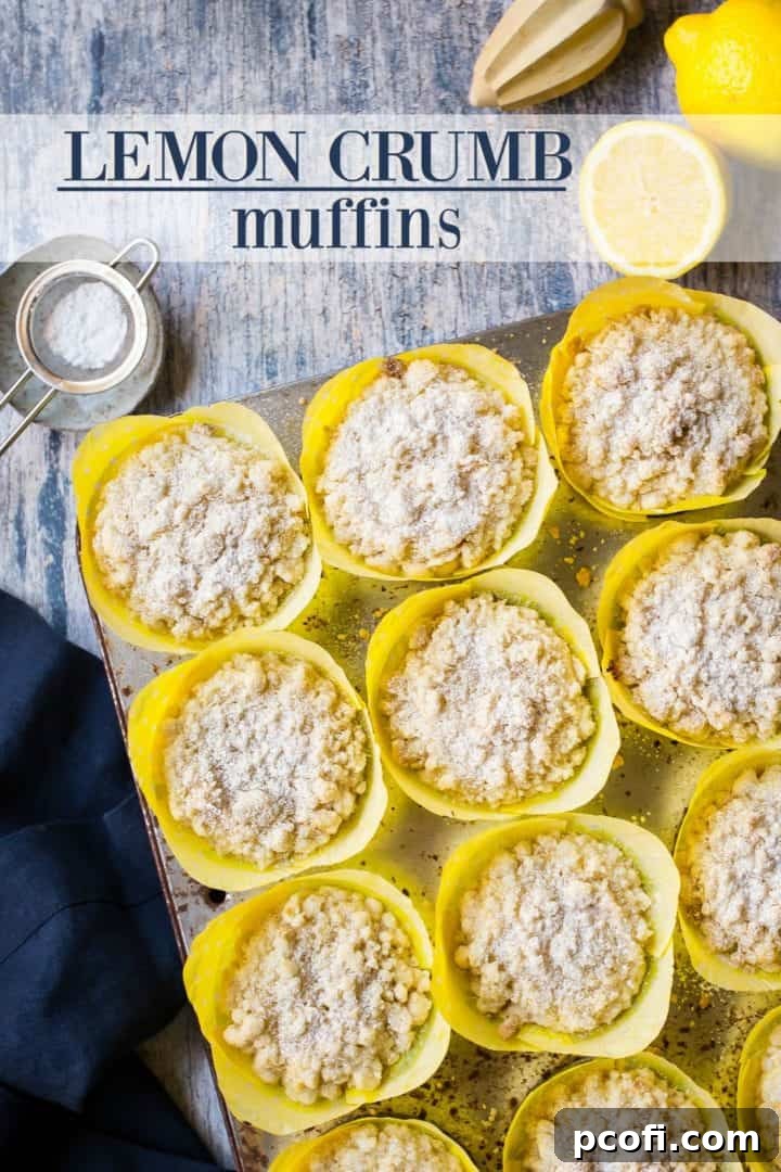 An inviting overhead shot of six lemon crumb muffins nestled in a muffin tin with bright yellow paper liners, adorned with a delicate dusting of powdered sugar. The text overlay reads 'Lemon Crumb Muffins', emphasizing the delicious treat.