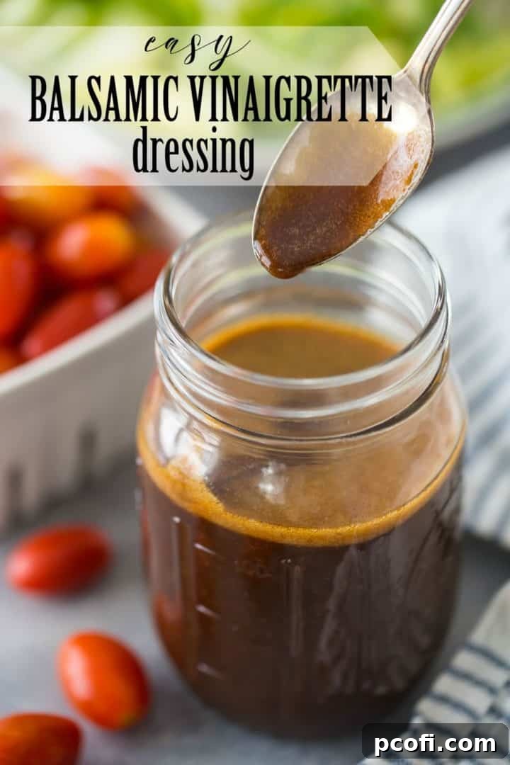 A close-up shot of a spoon expertly drizzling homemade balsamic vinaigrette dressing from a glass jar, with a clear text overlay reading 'Easy Balsamic Vinaigrette Dressing' for emphasis.