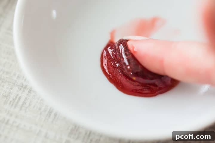 Pushing jam on a cold saucer to see if it will set properly.