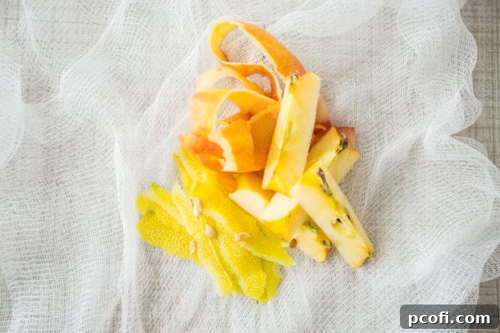 Lemon and apple peels, apple cores, and lemon seeds on cheesecloth.