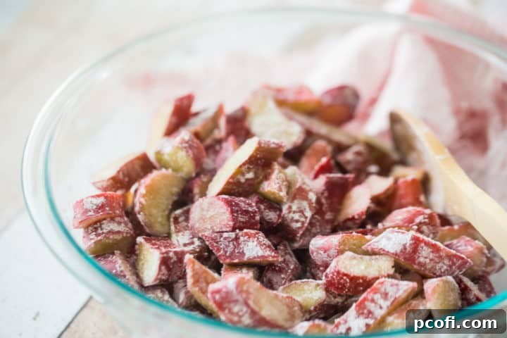 Rhubarb crisp filling in a large glass mixing bowl.