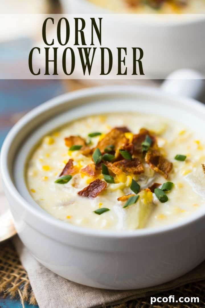 Corn chowder with bacon and chives in a white crock, with a text overlay reading "Corn Chowder."