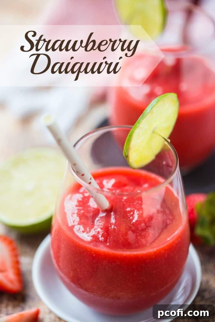Two stemless wineglasses with frozen strawberry daiquiris and a text overlay above reading "Strawberry Daiquiri."