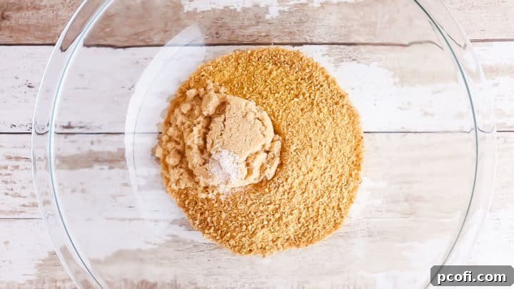 Graham cracker crumbs, brown sugar, and salt in a large glass mixing bowl.