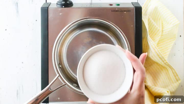 Placing sugar in a small pot.