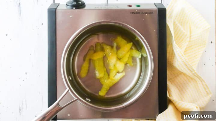 Lemon simple syrup in a small stainless steel pot.